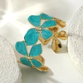 Close-up of golden stainless steel bangle with turquoise enamel flower patterns on white stone - Blue (FYD6238SZ)