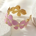 Detail shot of golden bangle featuring five pink enamel flowers with spiral textures - Pink (FYD6238SZ)