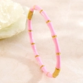 Macro detail of pink enamel and 18k gold plated stainless steel bamboo joint bracelet - Pink