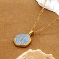 Gold stainless steel cross necklace with marble octagonal pendant on natural background - Octagonal Cross Pendant Necklace (FSY094XL-blue)