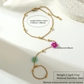 Detail of a gold stainless steel hand harness with beaded rose and mint flower charms - Purple Green Style (BG040-purple-green)