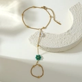 Macro shot of gold stainless steel finger chain bracelet with colorful flower charms - White Green Style (BG040-white-green)