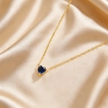 Elegant gold heart necklace featuring a deep blue December birthstone on silk - Dark Blue