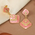 Detail of gold-plated geometric drop earrings with pink marble enamel and bead accents - Red