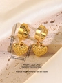 Detail of gold heart earrings with hammered texture on a stone base and silk fabric - Hammered Hollow Heart Style