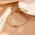 Luxurious 18k gold plated brass cross bracelet displayed on elegant champagne silk fabric - Horizontal Cross Charm Style (FSY049SL)