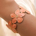 Detail of a gold C-shaped cuff bracelet featuring orange enamel marble-textured flowers - Red (FYD6209SZ-red)