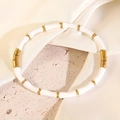 Bamboo style beaded bracelet with white segments and golden metal spacer beads - White