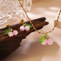 Sweet pink cherry jewelry set with necklace and earrings on a rustic wood stand - Jewelry (LM006) / Pink