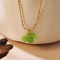 Elegant gold necklace with a translucent green cherry pendant on a white ceramic background - Necklace (LM006) / Green