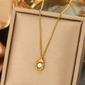 Golden stainless steel necklace with organic pea-shaped pendant and white pearl - Single Pearl Pendant