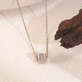 Macro detail of rose gold geometric cylinder pendant with inlaid zircon stones - Rose Gold Zirconia Bead (D14)