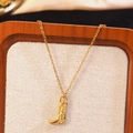 Vintage gold cowboy boot pendant necklace with intricate engraved details on burlap stand - Cowboy Boot Necklace (BG049XL)