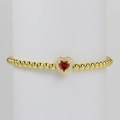Golden bead bracelet with a 18k gold heart pendant featuring a red stone and white zircons - January Bracelet