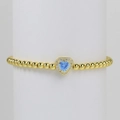 18k gold-plated beaded bracelet featuring a heart-shaped light blue stone pendant - March Bracelet