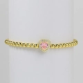 Beaded gold bracelet featuring a pink heart zircon pendant with micro-paved white stones - October Bracelet
