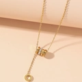 Gold titanium steel tassel necklace with interlocking Roman numeral rings and zircon inlay - Gold