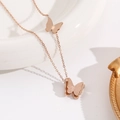 Élégant collier pendentif papillon en or rose 18 carats sur un plat en céramique - Style Double Papillon (X1223) / Or rose