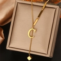 Close-up of golden letter C necklace with long tassel and square charm on satin - Letter C (WY006-C)