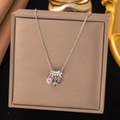Silver necklace with pink heart-shaped stone and purple crystal pendant on dark display - Pink Heart Star (8302)