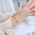 Elegant gold titanium steel bracelet with sparkling micro-pave zirconia crystals on wrist - Gold (4133)