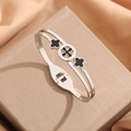 Silver steel bangle with black clover motifs and sparkling crystals on a satin box - Black Shell Four-Leaf Clover Rhinestone Style (Z266B) / Steel