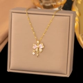Makroaufnahme einer goldenen Schleifenhalskette mit rosa Herzsteinen und Zirkonia-Akzenten - Stern Schleife (9104) / Gold