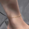 Minimalist 18k rose gold plated titanium steel anklet on woman ankle with fine link chain - Snake Bone Bracelet / Gold