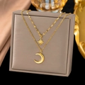 Double-layered gold necklace set with starburst pendant and crescent moon charm on display - Star Moon Necklace (H413) / Gold