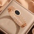 Rose gold titanium bangle with hollow honeycomb design and black oval enamel center inlay - Rose Gold