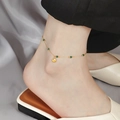 Elegant gold anklet with deep green beads and small shell charm worn on woman's ankle - B5044 Green Bead and Shell Charm Anklet Gold
