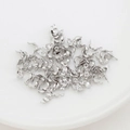 Detailed macro view of high-shine silver bead tips for jewelry making and bead capping - 3.6mm / White Gold