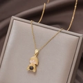 Golden necklace with a Buddha pendant featuring a pink stone and black bead - Projection Little Buddha