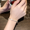 Elegant double-layered bracelet with white pearls and silver faceted beads on wrist - Double Layer Artificial Pearl Bracelet