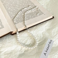 Detail of pearl and silver bead necklace with heart pendant on vintage book background - Small Artificial Pearl Style / Silver