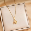 Golden titanium steel butterfly necklace featuring pink zircon stone wings on gift box - Colored Zirconia / Gold (X171)