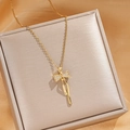 Elegant gold titanium necklace featuring a sparkling zircon bow pendant on a jewelry box - Gold Tassel Bowknot