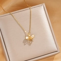 Close-up of golden bow pendant necklace with zircon stones on a luxury jewelry box - Gold Enamel Bowknot