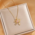 Golden bow pendant necklace with pink zircon stone on a luxury champagne gift box - Gold Pink Zircon Bow