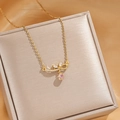 Elegant gold titanium necklace featuring a sparkling pink heart pendant with a bow design - Gold Pink Heart Bow