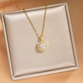 Elegant gold titanium necklace featuring a round flower pendant with sparkling zircon accents - Gold Rotating Necklace