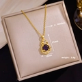 Macro shot of gold necklace with purple zircon pendant and product dimensions - Lucky Stone Gourd (D64)