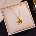 Detailed macro view of gold-plated flower pendant with purple zircons and crystals - Lucky Stone Flower (D61)