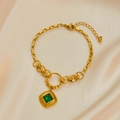 Vintage gold-plated bracelet with square emerald gemstone pendant on white satin - Emerald Bracelet
