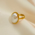 Vintage gold-plated titanium steel ring featuring a large oval pearl on silk background - Pearl Ring