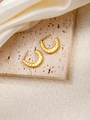 Detailed macro view of gold U-shaped twisted earrings with honeycomb textured surface - C-Shaped E0175 Style