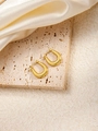Detail of golden U-shaped hoop earrings with honeycomb texture on stone and satin background - U-Shaped E0177 Style