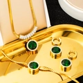 Primer plano de conjunto de collar y pulsera de oro con piedras preciosas verde esmeralda - Conjunto de Joyas de 3 Piezas de Redondo Esmeralda