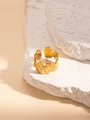 Golden leaf-shaped titanium steel open ring with textured brushed finish on white stone - Gold Continuous Leaf Style