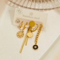 Macro detail of elegant gold stainless steel earring set with crystal and star pendants - Star Hexagon Style
